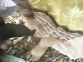 A slender Indian girl gives her boyfriend a sensual outdoor massage