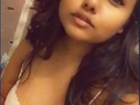 A cute Indian girl flaunts her large breasts and intimate area in a selfie video