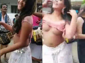 Two naked prostitutes dance provocatively in public place, attracting attention