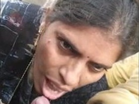 Randi, a mature woman, gives a blowjob to a customer in a car