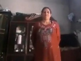 A Pakistani woman removes her clothes to reveal her breasts and genitals