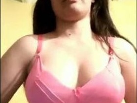 A young Desi girl flaunts her large breasts in a video