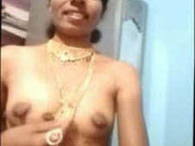 Aunty with traditional jewelry bares her breasts and pussy